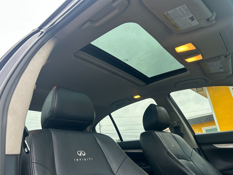 Infiniti sunroof and black leather interior seen from the rear seats