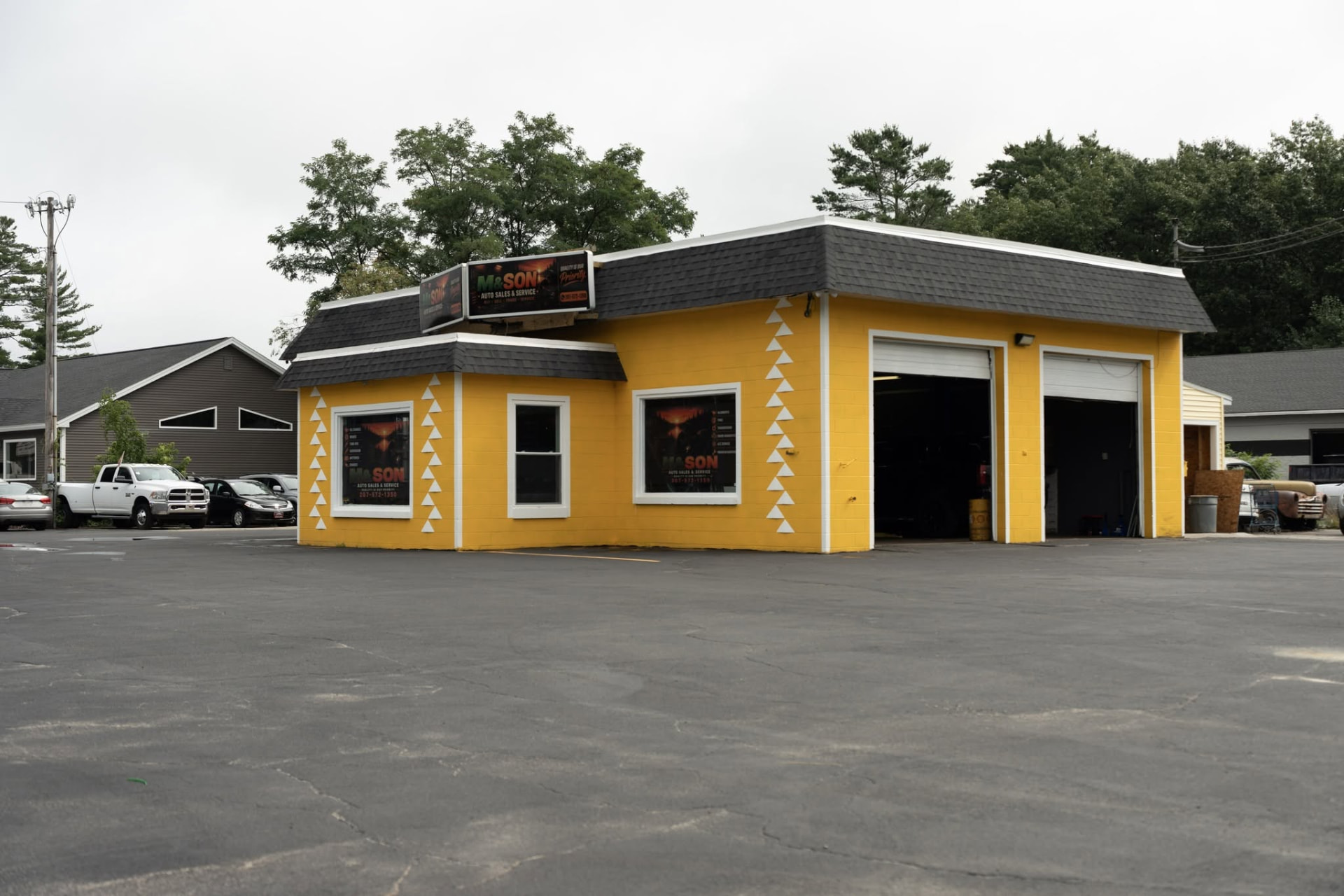 The yellow M & Son shop building on Route 302 with two open service bays